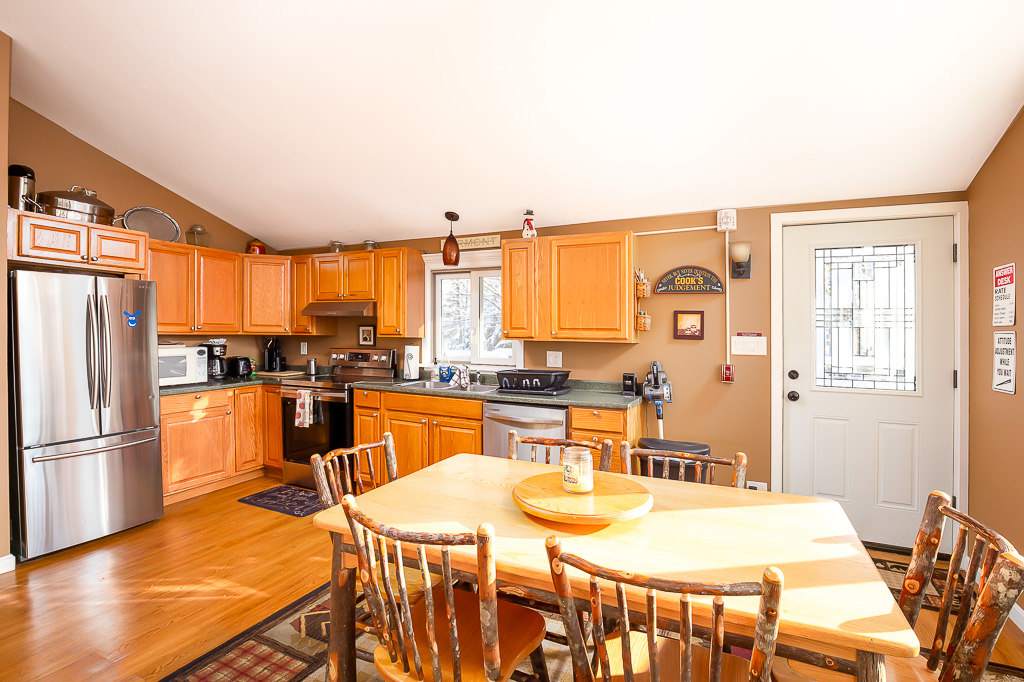 Eat-in kitchen with stainless appliances and hickory dining set
