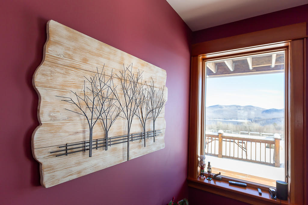 Carved tree wall art with picture-window mountain view