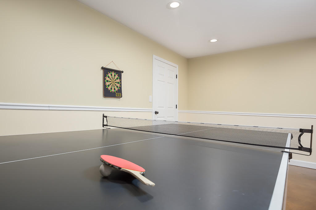 Ping pong table with paddle and magnetic dartboard