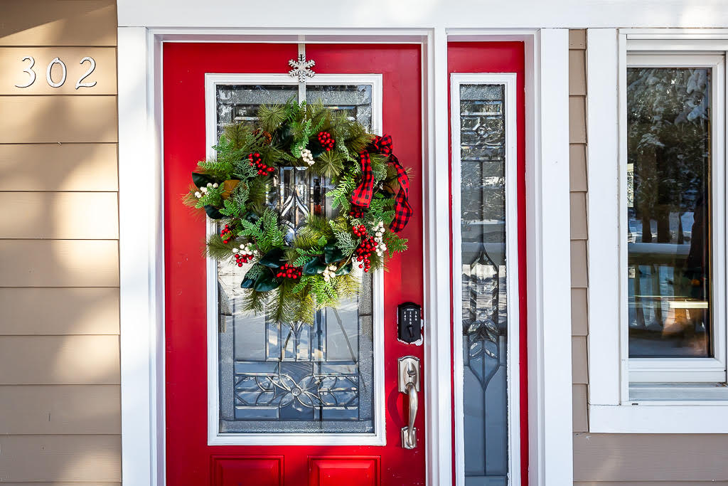 Welcoming red front door with holiday wreath at 302