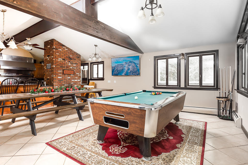 Game room with pool table, picnic dining, and vaulted ceilings