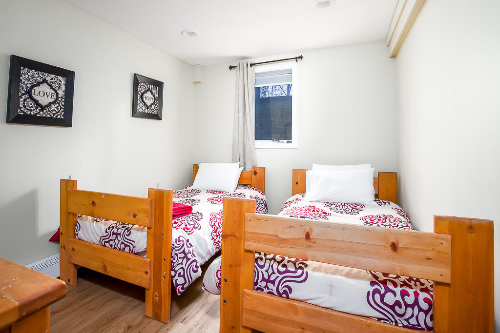 Twin bedroom with pine bed frames, ideal for kids or extra guests
