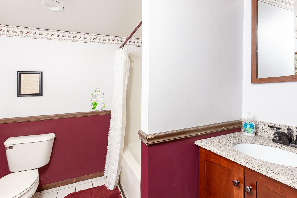 Additional full bathroom with shower-tub combo and granite vanity